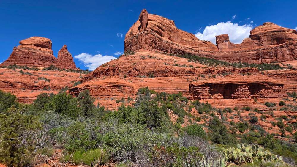 Red rock formations and blue sky in a desert landscape.